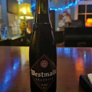 Brown Bottle with brown diamond label on a polish wooden surface