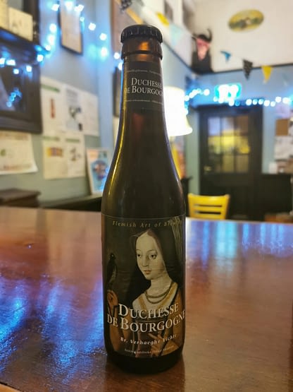 Bottle with a label showing a well-dressed lady